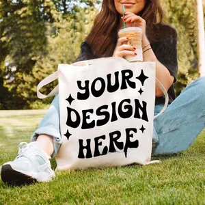 Outdoor lifestyle shot of a white canvas tote bag with custom printed art and black text