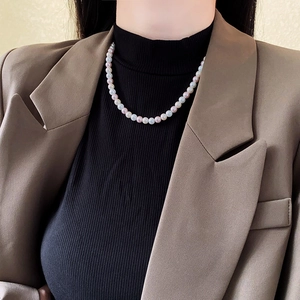 Detailed view of multi-color pearl necklace featuring white pink and lavender round pearls