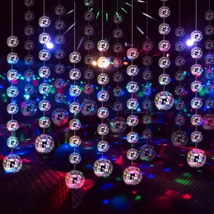 Vertical rows of silver mirror disco balls reflecting vibrant colorful party lights