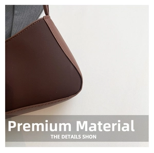 Close-up of fine stitching and smooth dark brown leather texture on a baguette bag