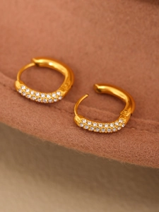 Macro shot of 14mm gold hoop earrings with double row micro-paved sparkling cubic zirconia