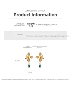 Detail view of vintage floral earrings with green teardrop stones and zircon inlay