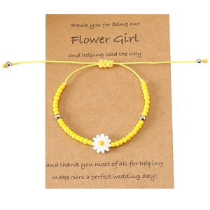 Yellow beaded daisy bracelet for flower girl gift on brown kraft thank you card