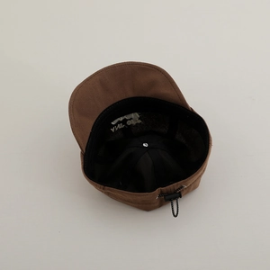 Detailed interior of the brown cotton baby cap featuring mesh lining and adjustable toggle