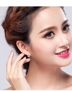 Close-up of s925 silver hoop earrings with micro-pave crystals on a female model