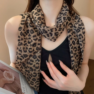 Detail of leopard print silk scarf showing neck styling and brown chiffon fabric texture