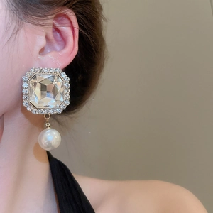 Detail of square crystal pearl drop earring with shimmering micro-pave diamond borders