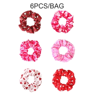 Set of 6 red and pink Valentine scrunchies with heart and lip patterns on white background