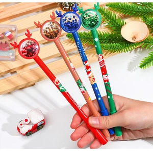 Close-up of colorful Christmas reindeer pens featuring liquid glitter and sequin tops