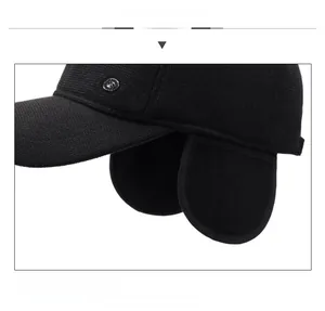 Detail view of winter baseball cap showing ear flaps and retro metal buckle detail