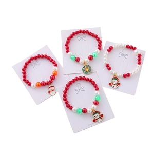 Christmas beaded bracelets with festive snowman and bell charms on display cards