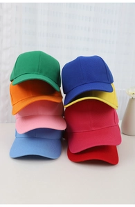 A variety of colorful baseball caps stacked together in soft natural lighting scenery