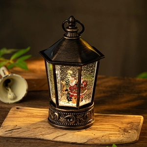 Vintage bronze Christmas lantern with Santa Claus figurine and sparkling snow globe light