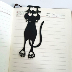 Creative black cat silhouette bookmark hanging on notebook page for cute stationery lovers