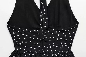 Close-up of backless halter polka dot top showing fine stitching and fabric texture