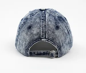 Back view of washed blue denim baseball cap showing acid wash texture and metal buckle