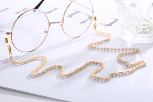 Detail of beaded glasses chain with champagne faceted beads and gold lobster clasps