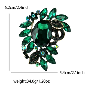 Detailed view of large green faceted gemstone brooch with precise size and weight measurements