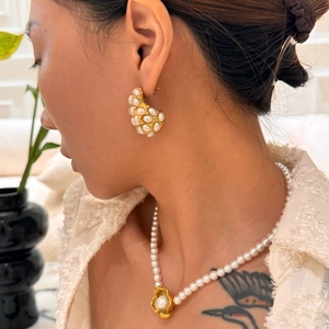 Vintage hollow teardrop pearl earrings and matching necklace set on female model