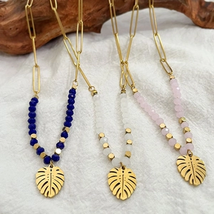 Bohemian beaded necklaces with gold monstera leaf pendants in blue, white and pink
