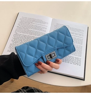 Detail of dark blue quilted leather long wallet with vintage metal twist lock clasp