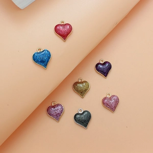 Close-up of colorful glittery heart pendants with metal frames in various vibrant colors