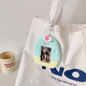 Plush cartoon dessert card holder with colorful pom-poms hanging on a canvas bag