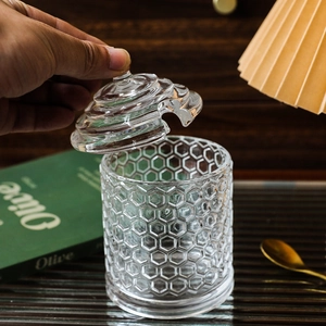 European honeycomb glass storage jar with a lid and cutout for a spoon handle