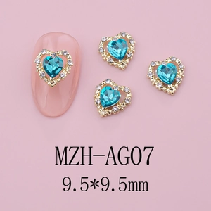 Macro detail of heart-shaped nail charm MZH-AG07 with blue crystal and gold rhinestone border