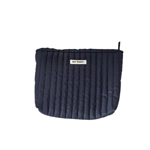 Schwarze gesteppte Kosmetiktasche mit Reißverschluss und weißem Etikett auf weißem Grund