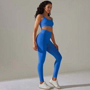 Vista laterale del set da yoga a coste blu reale con reggiseno sportivo e leggings alti