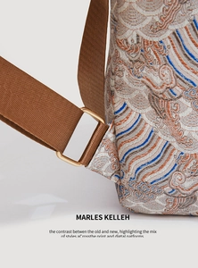Detail of silk jacquard fabric and golden metal buckle on Chinese style backpack strap