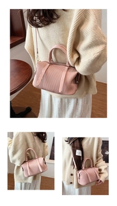 Macro view of pink pleated Boston bag showing fine organza texture and dual handles