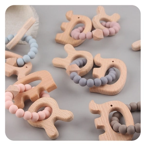 Close-up of beech wood elephant teether and colorful silicone bead bracelets for babies
