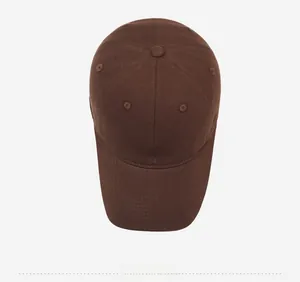 Close-up of a dark brown cotton baseball cap featuring detailed white animal embroidery
