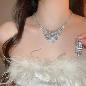 Close-up of model wearing silver zircon square tassel necklace and earring set
