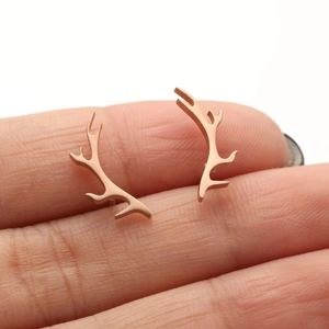 Elegant rose gold stainless steel reindeer antler stud earrings for women on model