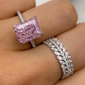 Detail of radiant cut pink gemstone ring with multi-row marquise diamond band