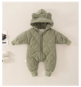 Close-up of diamond quilted baby romper with bear ears hood and front zipper closure