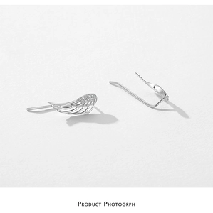 Detail of silver angel wing earring featuring micro-pave cubic zirconia setting