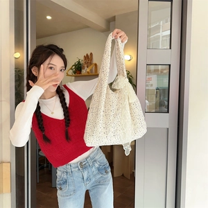 Close-up of floral pattern canvas tote bag with lace detail styled on a shoulder