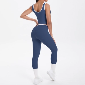 Detail view of high-waist yoga set showing navy fabric and white contrast piping
