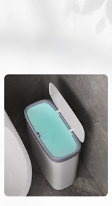 Detail showing the narrow trash can with a sealed lid to prevent odors in bathrooms