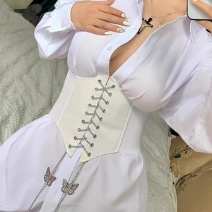 Detail of white corset belt with silver butterfly chain and lace-up ribbon design
