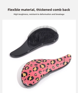 Detail of leopard print massage hairbrush showing flexible bristles and durable thickened back