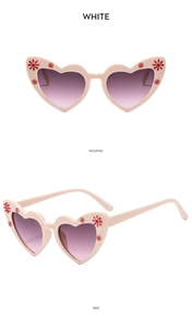 Detail view showing heart-shaped sunglasses with daisy floral patterns and purple lenses