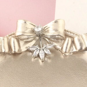 Macro shot of silver belly ring featuring fan-shaped marquise-cut zircon cluster detail