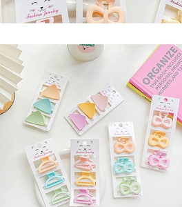 Detail showing assorted pastel macaron claw clips set on stylish fashion cards