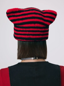 Detailed close-up of handmade knit cat ear beanie with red and black stripe pattern