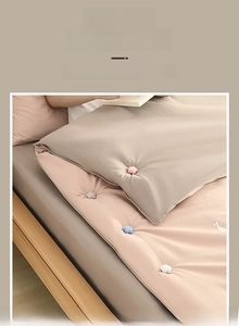 Detail of flower-shaped duvet clips in pink, blue, grey, and white cotton fabric